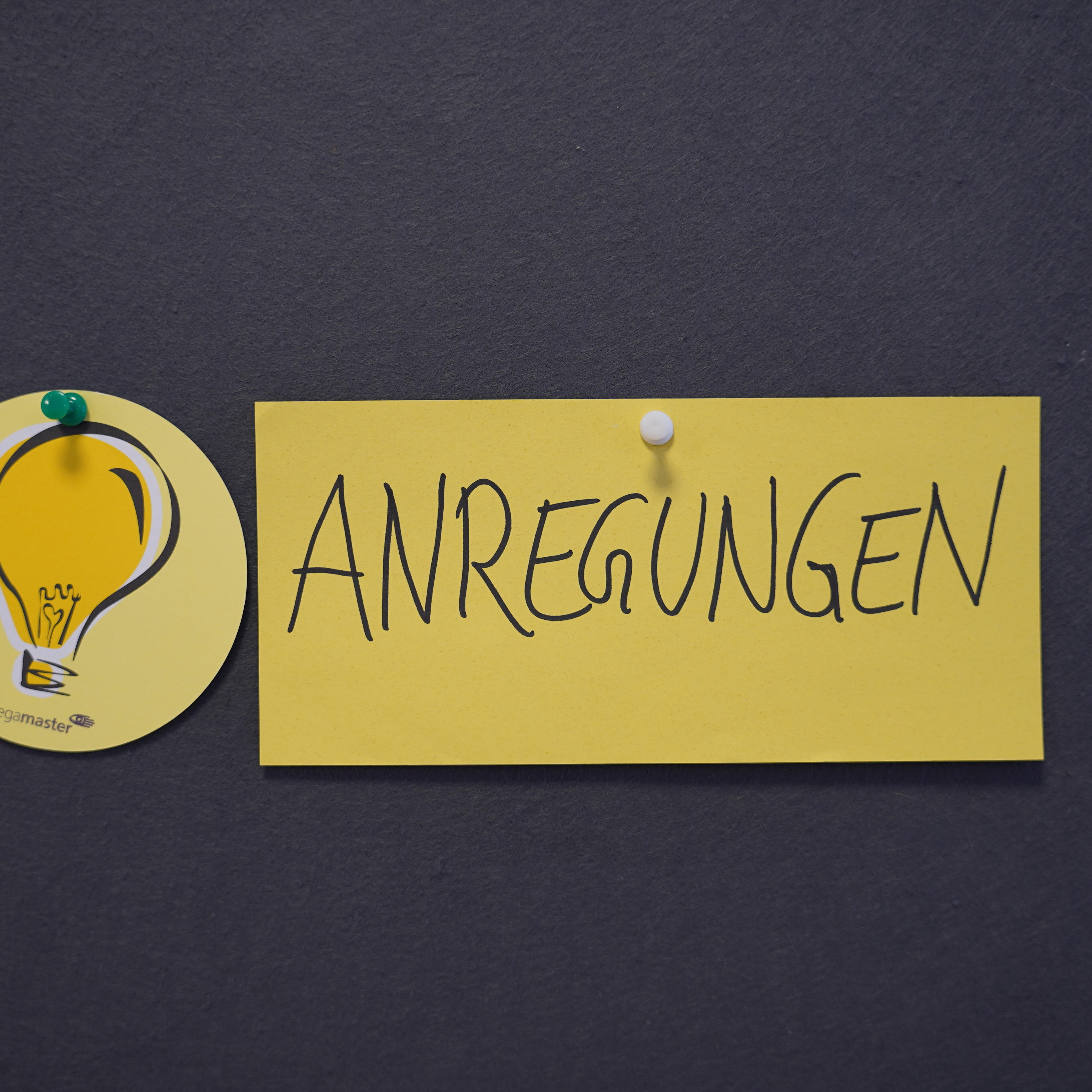 Pinwand mit gelbem Post it auf dem "Anregungen" geschrieben steht